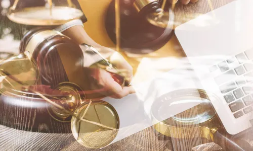 Contract papers with brass scale on desk in office justice and law concept picture with film grain effect.jpg